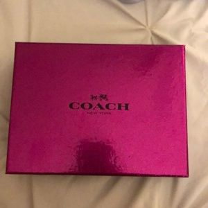 A Coach Cranberry colored wrist wallet